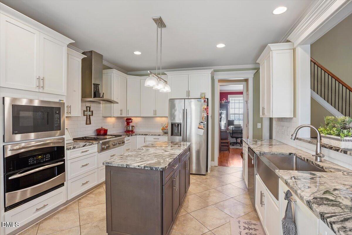 1001 Bellewood Farms Road Raleigh, NC 27603 - Photo 23 of 39 a large kitchen with stainless steel appliances granite countertop a sink stove and refrigerator