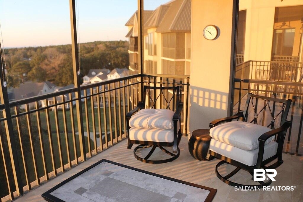 18269 Colony Drive, Unit 803 Fairhope, AL 36532 - Photo 26 of 27 Balcony at dusk with a sunroom