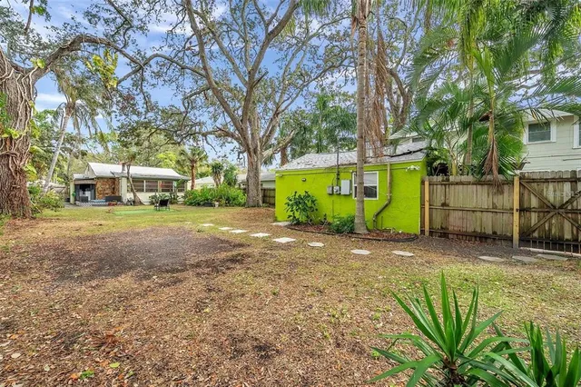 a view of a street with a building and trees in the background