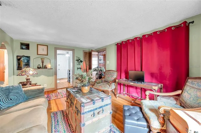 a living room with furniture a flat screen tv and a window