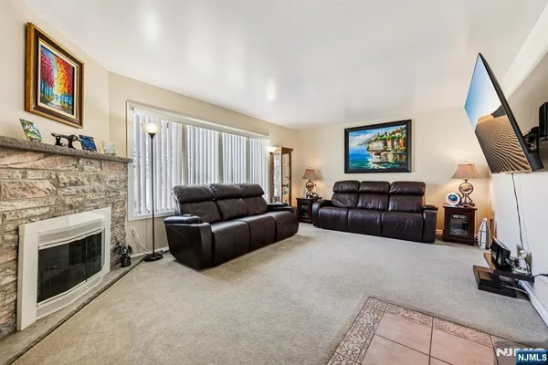 a kitchen with kitchen island granite countertop a sink a counter top space appliances and cabinets