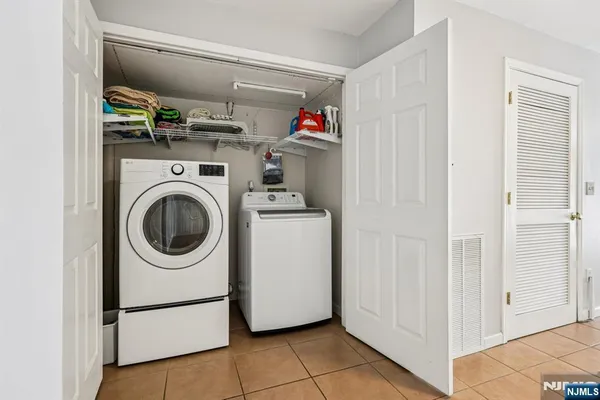 a bathroom with a toilet sink vanity and mirror