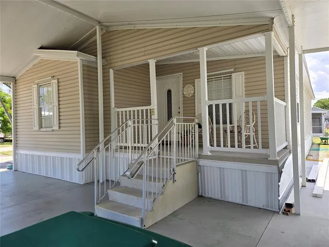 a living room with furniture a chandelier and a flat screen tv