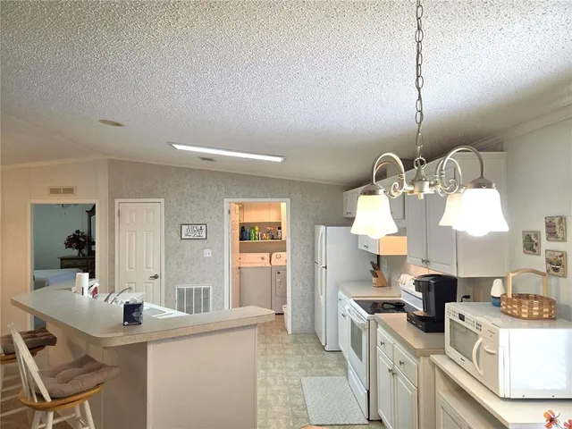 a dining room with furniture and a chandelier