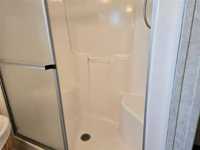 a living room with a bed and a window