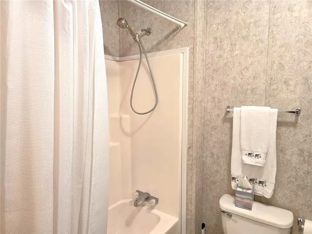 a view of empty room with closet and flat screen tv