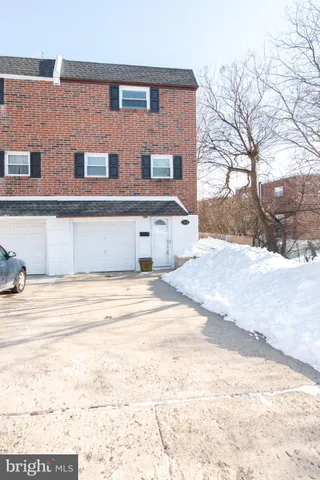 a view of a building with a snow on the road