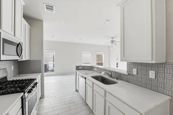 a kitchen that has a sink and a stove