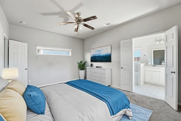 a bedroom with a large bed and a flat screen tv