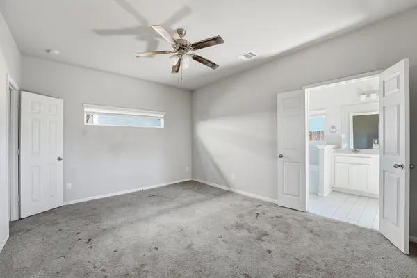 a view of a big room with closet and windows