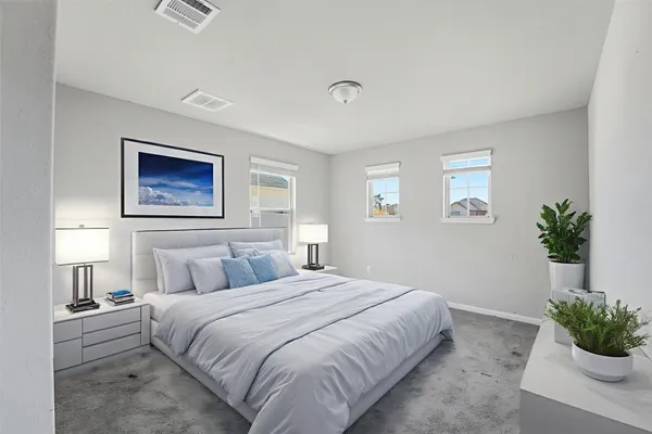 a bedroom with a bed and a potted plant