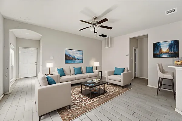 a living room with furniture and a flat screen tv