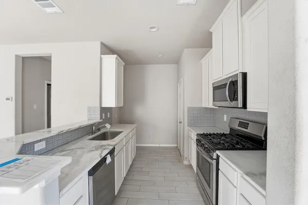 a kitchen with a stove and a sink