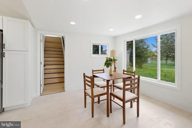 a dining room with furniture and window