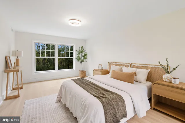 a bedroom with a large bed and a window