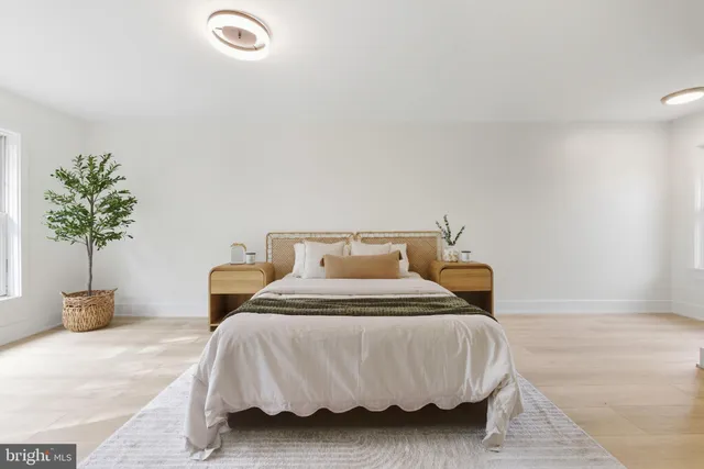 a bedroom with a bed and ceiling potted plant