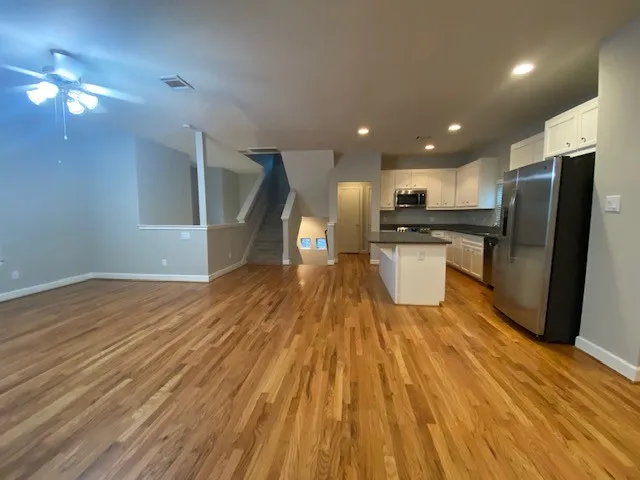 a kitchen with stainless steel appliances granite countertop a refrigerator and a stove top oven