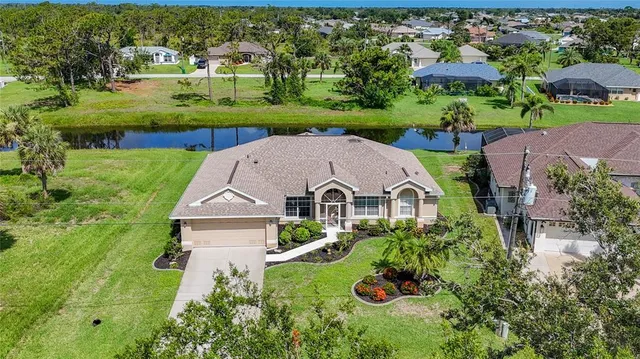 an aerial view of a house with garden space and street view