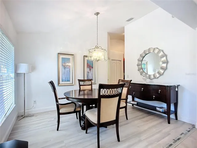 a living room with furniture a flat screen tv and a window