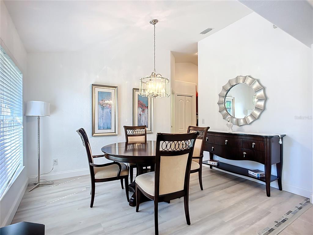 123 Marker Road Rotonda West, FL 33947 - Photo 15 of 66 a view of a dining room with furniture and chandelier