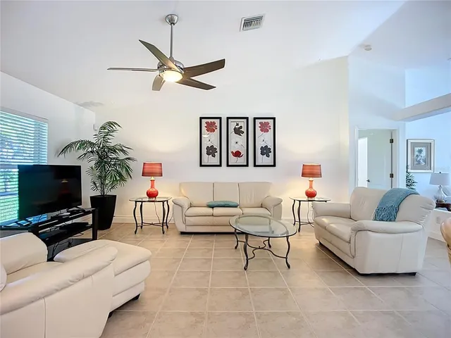 a dining room with furniture and a flat screen tv