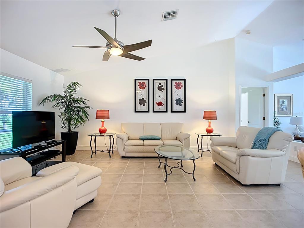 123 Marker Road Rotonda West, FL 33947 - Photo 21 of 66 a living room with furniture and a flat screen tv