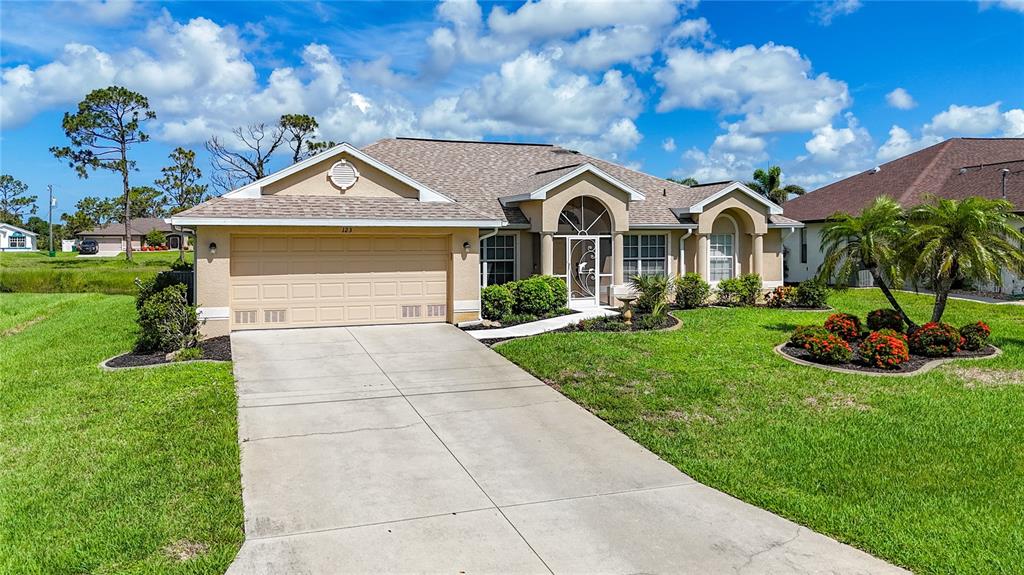123 Marker Road Rotonda West, FL 33947 - Photo 3 of 66 a front view of a house with garden