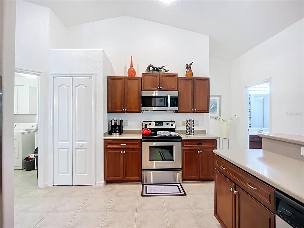 123 Marker Road Rotonda West, FL 33947 - Photo 32 of 66 a kitchen with stainless steel appliances a stove and cabinets