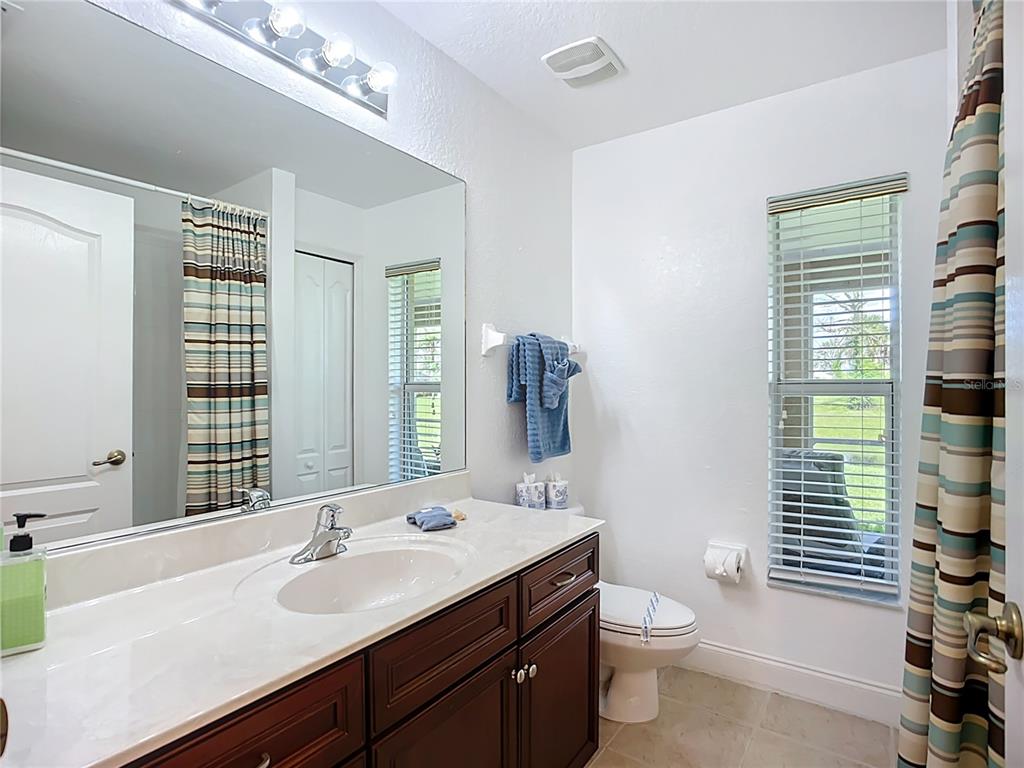 123 Marker Road Rotonda West, FL 33947 - Photo 36 of 66 a bathroom with a double vanity sink toilet and shower
