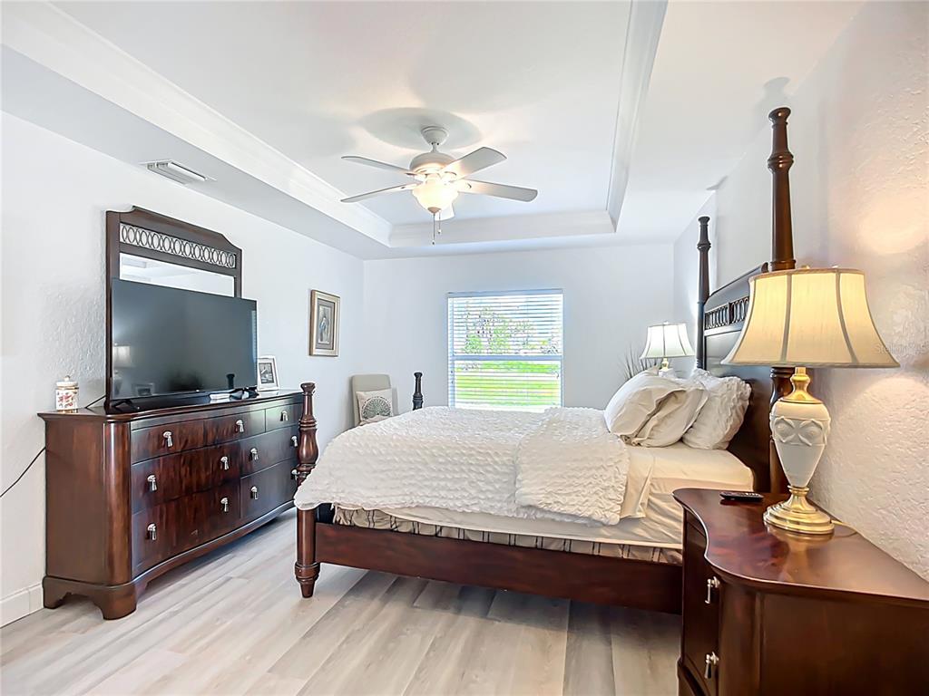 123 Marker Road Rotonda West, FL 33947 - Photo 42 of 66 a bedroom with a bed and a flat screen tv