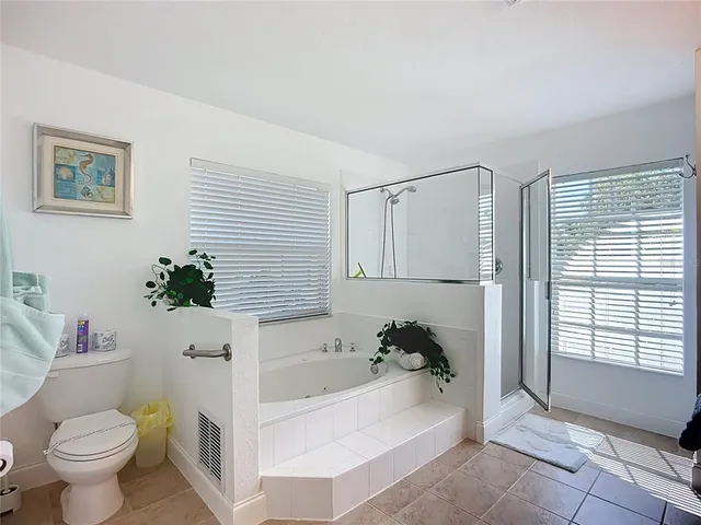 a dining room with furniture and a floor to ceiling window