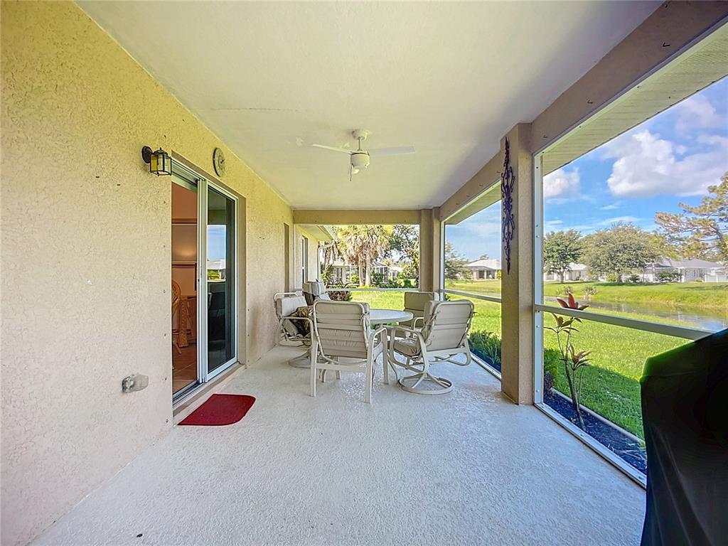 123 Marker Road Rotonda West, FL 33947 - Photo 51 of 66 a living room with furniture and a floor to ceiling window
