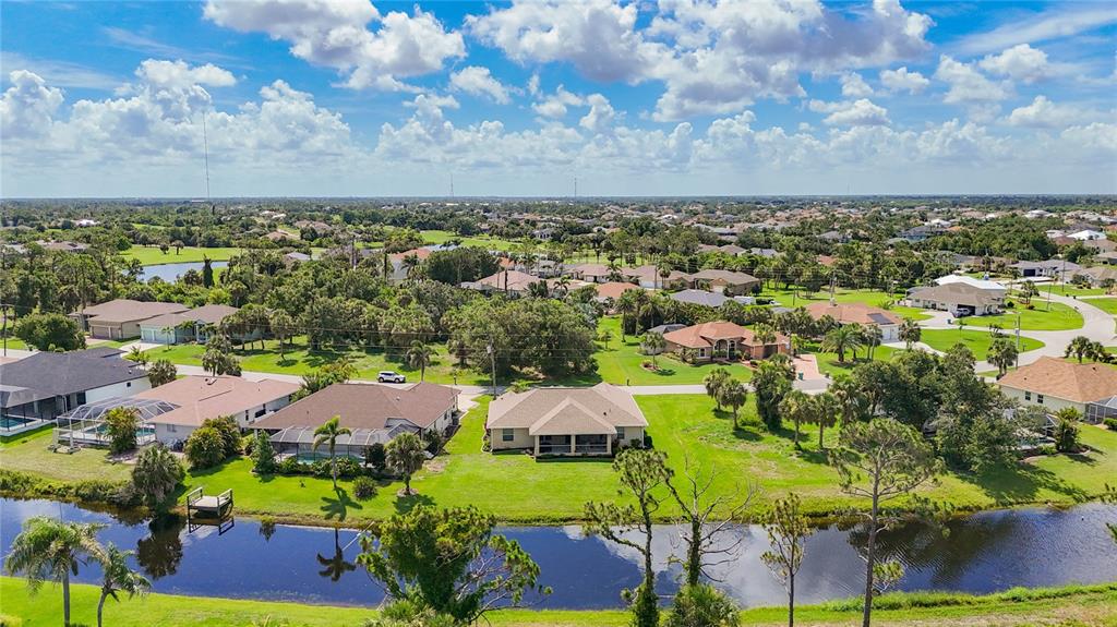 123 Marker Road Rotonda West, FL 33947 - Photo 63 of 66 an aerial view of residential houses with outdoor space and trees