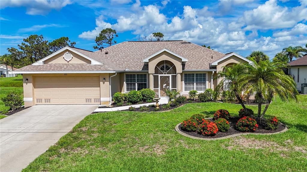 123 Marker Road Rotonda West, FL 33947 - Photo 9 of 66 a front view of a house with a garden