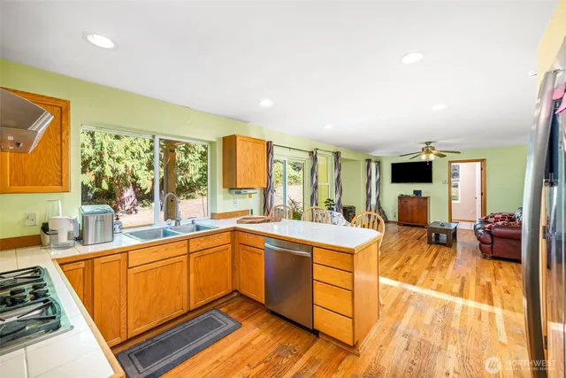 a open kitchen with stainless steel appliances granite countertop a sink and cabinets
