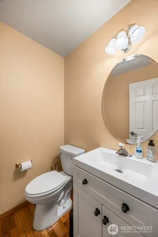 a bathroom with a sink mirror and toilet