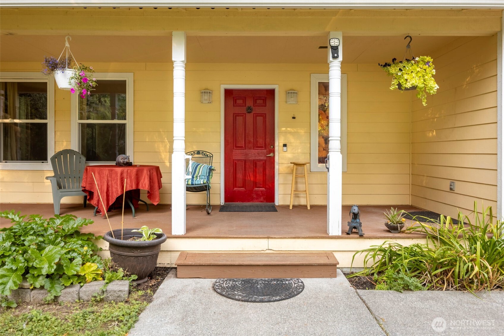 24165 Port Gamble Road Northeast Poulsbo, WA 98370 - Photo 2 of 37 a front view of a house with outdoor seating