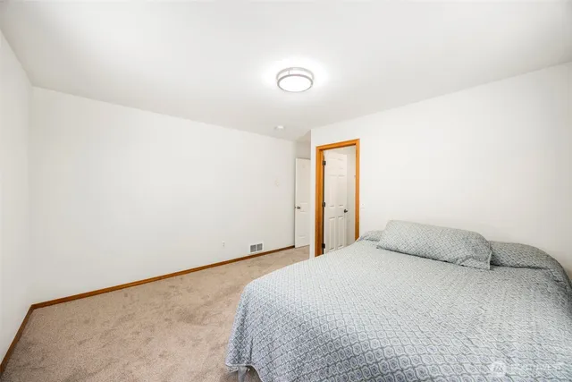 a bedroom with a bed and a night stand