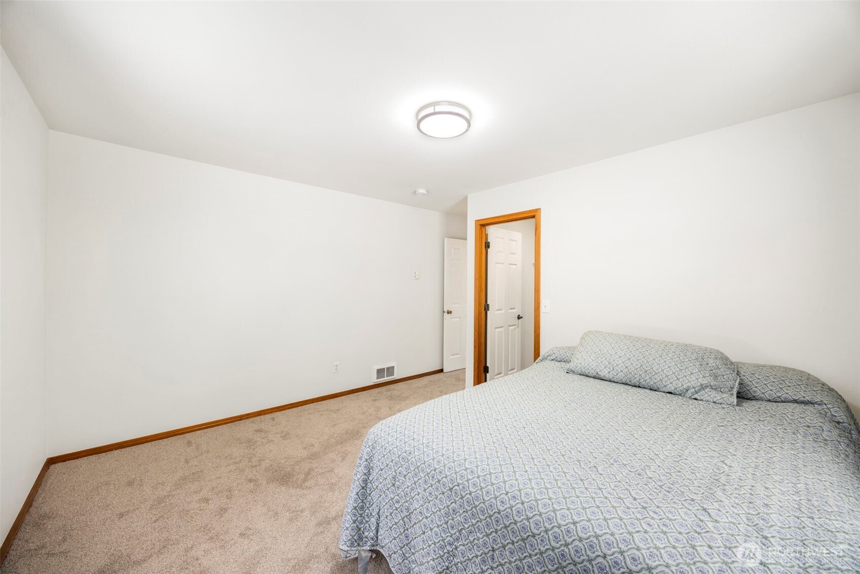 24165 Port Gamble Road Northeast Poulsbo, WA 98370 - Photo 21 of 37 a bedroom with a bed and a night stand