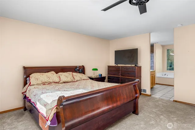 a bedroom with a bed and flat screen tv