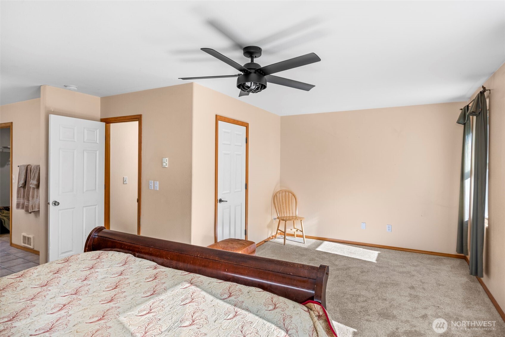 24165 Port Gamble Road Northeast Poulsbo, WA 98370 - Photo 28 of 37 a bedroom with a bed and a chandelier