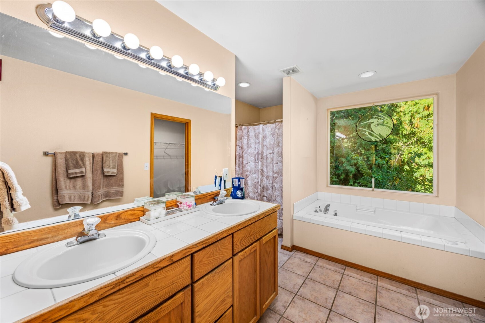 24165 Port Gamble Road Northeast Poulsbo, WA 98370 - Photo 30 of 37 a bathroom with a tub double sink window and mirror