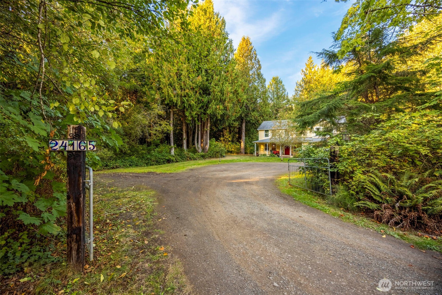 24165 Port Gamble Road Northeast Poulsbo, WA 98370 - Photo 3 of 37 a view of a road with a tree