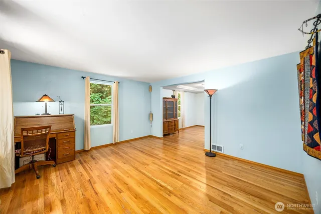 a view of a livingroom with a fireplace and a window