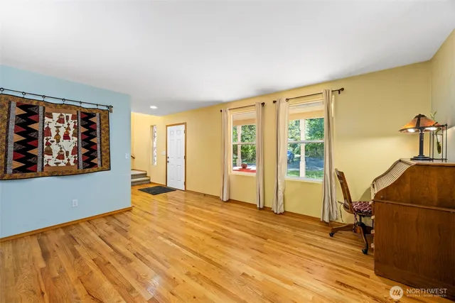 a view of workspace with wooden floor and furniture