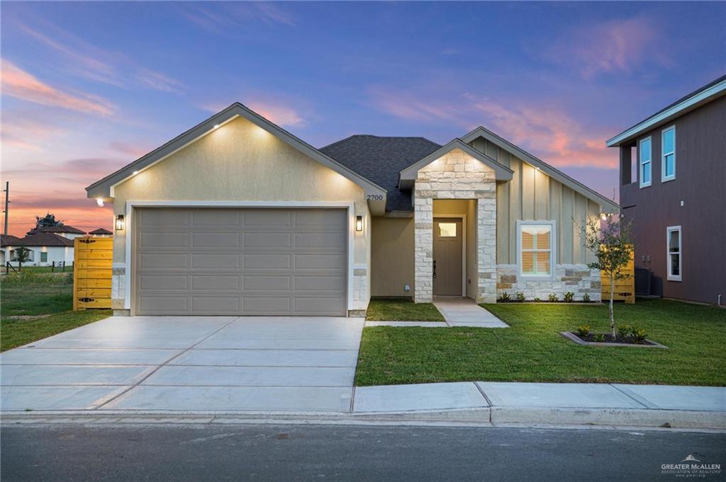 a front view of a house with a yard and garage