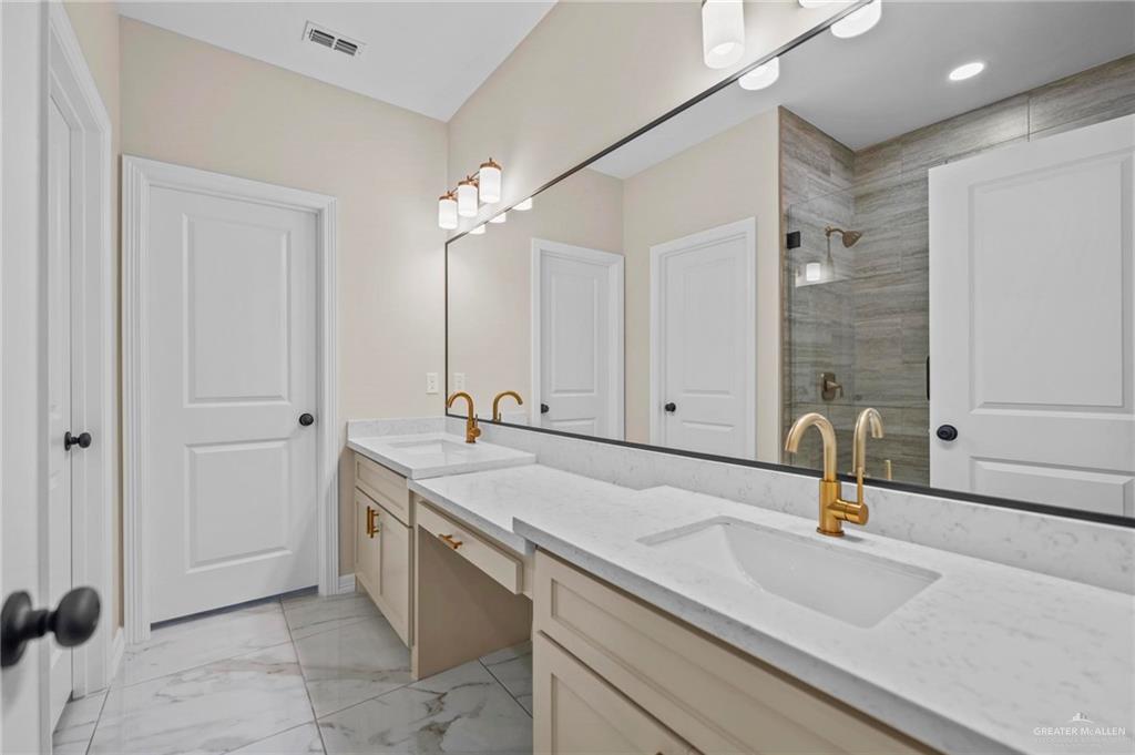2700 East Conroe Road Edinburg, TX 78542 - Photo 11 of 16 a bathroom with a sink and a mirror