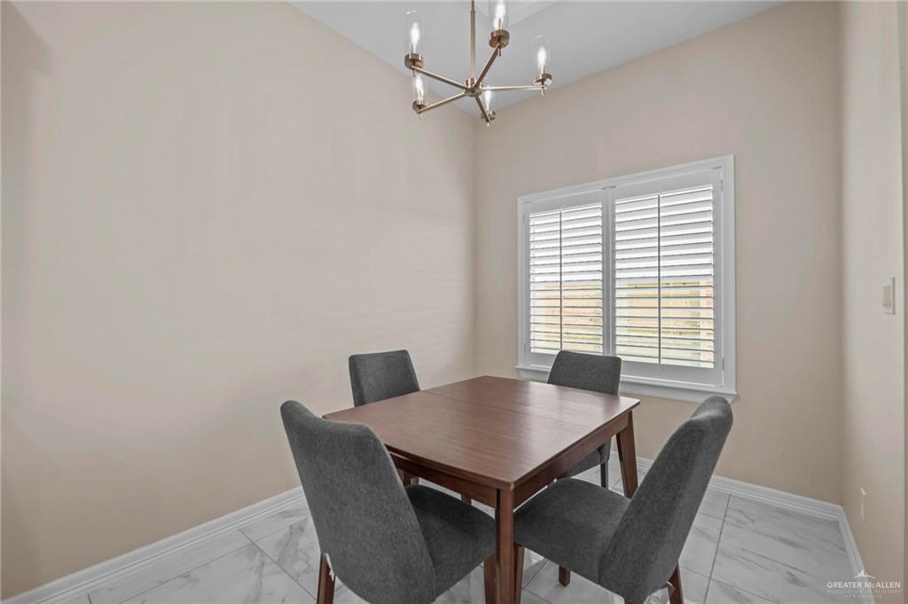 2700 East Conroe Road Edinburg, TX 78542 - Photo 9 of 16 a view of a dining room with furniture and a window
