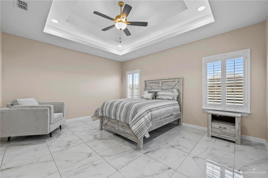 2700 East Conroe Road Edinburg, TX 78542 - Photo 10 of 16 a bedroom with a bed and a chandelier