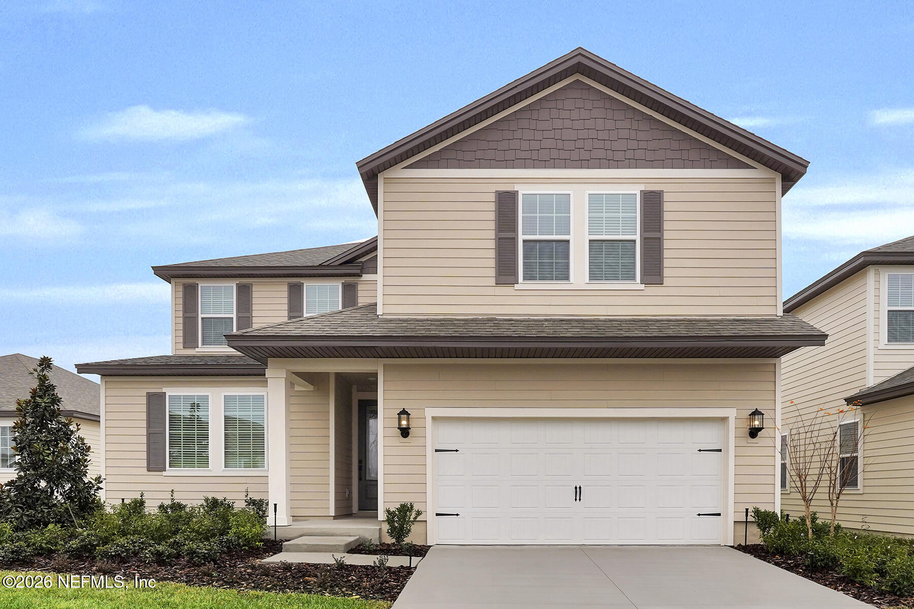 a front view of a house with garage